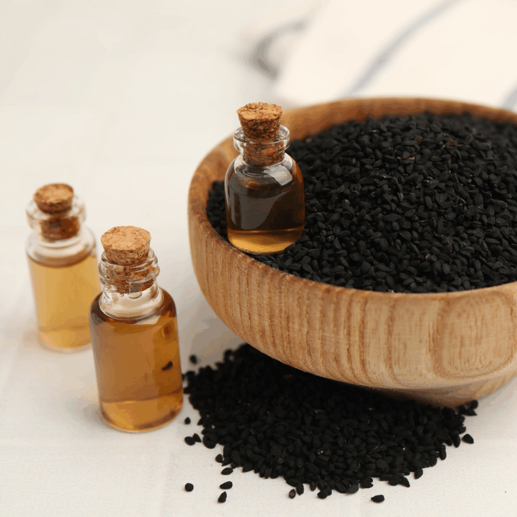 Cold pressed black cumin oil and Nigella seeds showcasing a premium specialty oil for food applications.